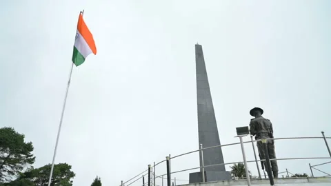 Slow motion video of tri colour Indian flag waving at memorial of Batasia loop Stock Footage 259449630
