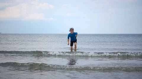 Slow-motion video of two happy children in neoprene swimsuits  playing with w Video stock 111658664