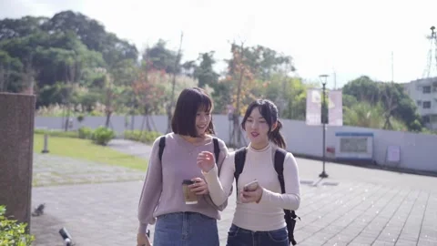 Slow-motion video of two Taiwanese female college students in their 20s walking Stock Footage 266956182