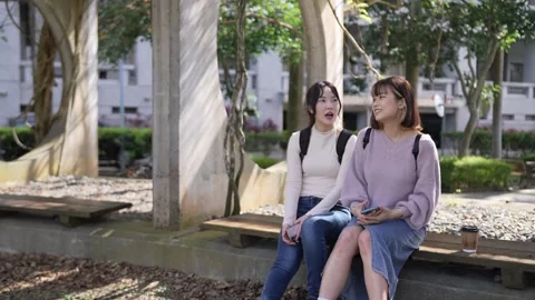 Slow-motion video of two Taiwanese female college students in their 20s sitting Видео 266966171