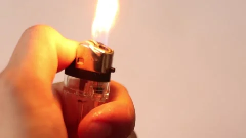 Slow Motion Video of Using a Lighter at White with Sparkles and Fire. Stock Footage 131845658