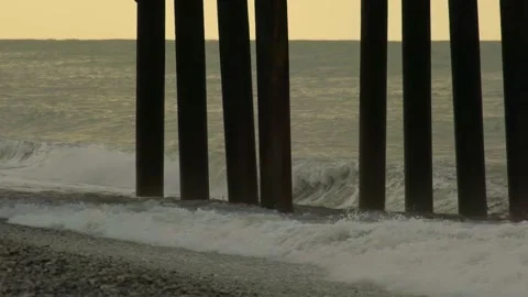 Slow motion video. View of the pier from the side on the seashore. Stock Footage 221347605