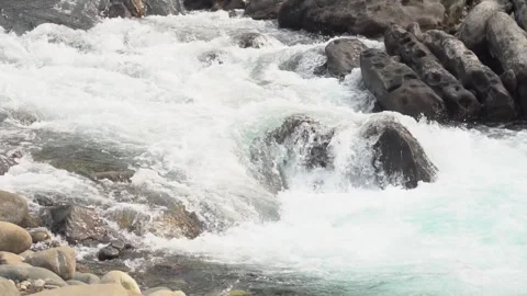 Slow motion video of water flowing through rocky landscape Video stock 304536258