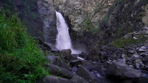 Slow motion video of a waterfall in the mountains Stock Footage 204564416