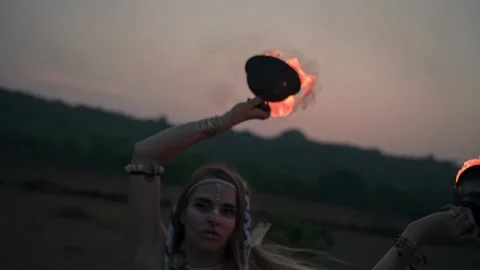 In the slow motion video, we can see a girl in a dress dancing dance with fire. Video stock 234021633