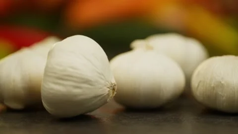 A slow-motion video in which a head of garlic flies into the frame. Stock Footage 296362034