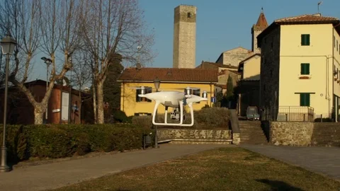 Slow motion video of a white quadcopter drone hovering in an ancient ita Видео 81739864
