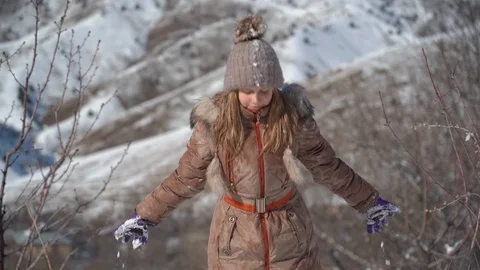 Slow motion video. A young cheerful girl with blond hair in the mountains, in Stock Footage 101243051