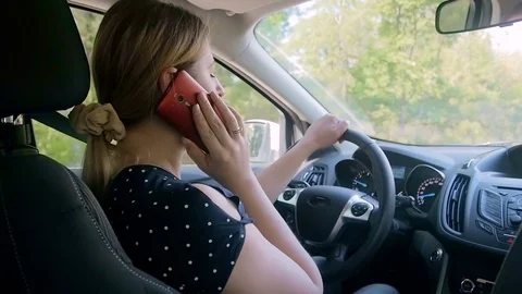 Slow motion video of young owman talking by phone while driving car Stock Footage 84001190