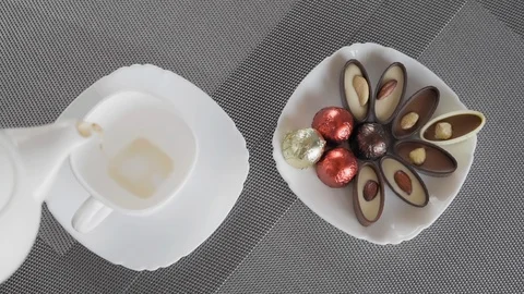 Slow Motion, View From Above, Tea Pours Into White Cup Standing Next to The Dish Stock Footage 127472812