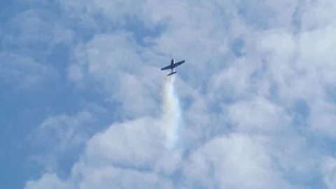 Slow motion view of an acrobatic airplane at an air show Stock Footage 80622782