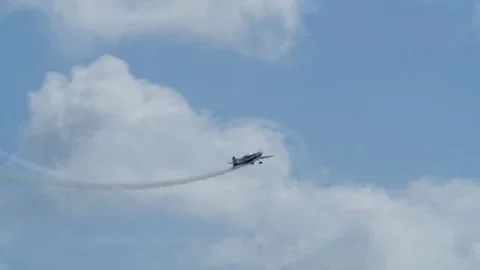 Slow motion view of an acrobatic airplane at an air show Stock Footage
