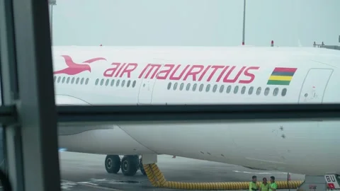 Slow-motion view of an Air Mauritius aircraft parked at KLIA, captured through Stock Footage 320999083