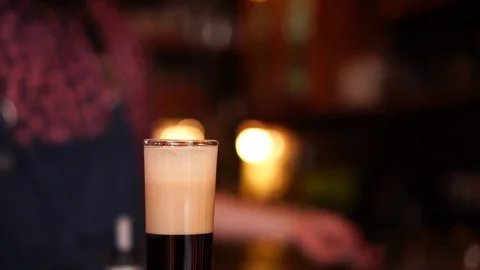 Slow motion view on alcohol classic cocktail coffee flavored shot glass beverage Stock Footage 103804896