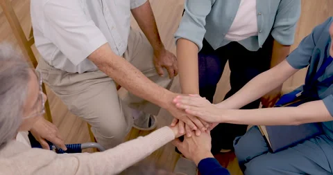 Slow motion view of Asian senior group and professional nurse stacking hands Stock-Footage 344517345