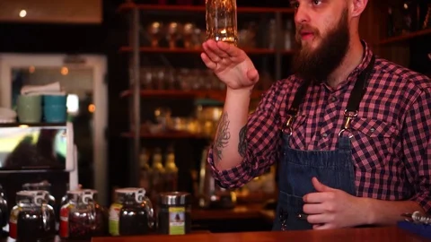 Slow motion view on attractive bartender with beard performing professional Video stock 103734714