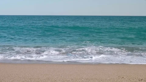 Slow motion view of beats of waves on sandy beach. Windy afternoon. Stock Footage 116414066