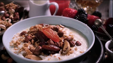 Slow motion view: berries falling over a bowl of yogurt Stock Footage 73738618