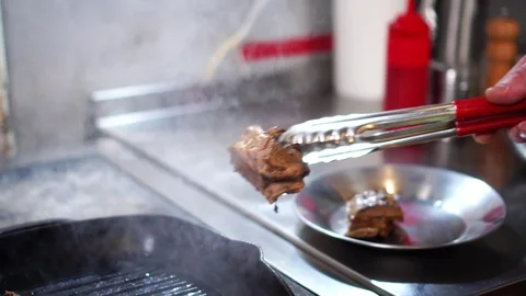 Slow motion view on chef cook putting prepared pork ribs delicious beef meat Stock Footage 105897606