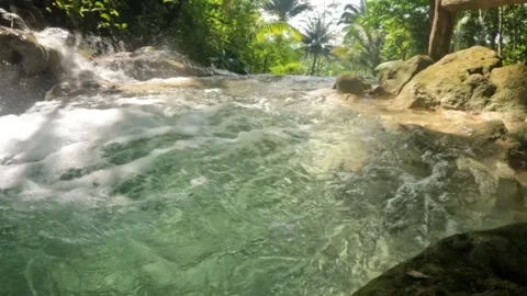 Slow motion view of a clear turquoise waterfall flowing gently Stock Footage 321860617