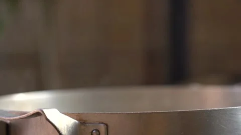Slow Motion view of The cook stirs the rice he is cooking in the pot Stock Footage 253215247