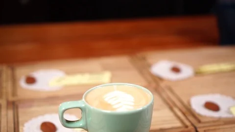 Slow motion view on cute minimalistic coffee cup with cappuccino and latte art Stock Footage 104510342