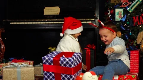 Slow motion view on cute sister tickling adorable little brother playing under Stock Footage 99117706