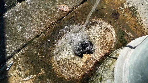Slow motion view of the drain, with water jet of a public fountain seen from abo Stock Footage 144452406