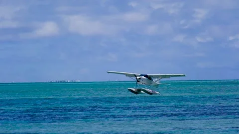 Slow motion view of a float plane landing near Le Morne in Mauritius Stock Footage 170072815