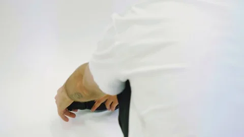 Slow motion view of hands making black fanny pack with white background ready Stock Footage 94956874