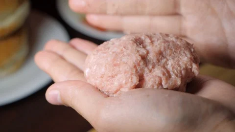 Slow motion view of hands shaping minced beef into a cutlet for a burger Video stock 123306023