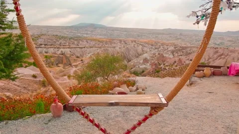 Slow motion view of heart shape wooden swings with nobody around in scenic va Stock-Footage 165948380