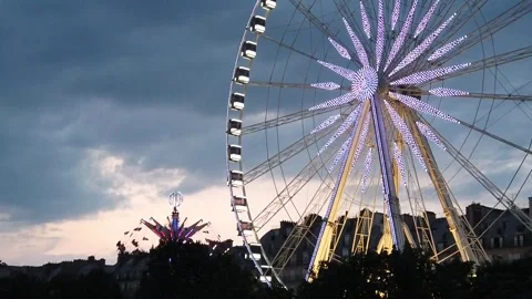 Slow Motion View of Illuminated Ferris Wheel in Paris During Sunset Stock Footage 327341629