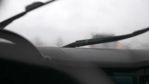 Slow motion view from inside of the car to windshield wiper blades on fast mode Stock Footage 270369655