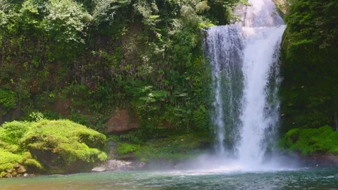 Slow motion view of Jion Falls pouring into emerald green pool Stock-Footage 341806414