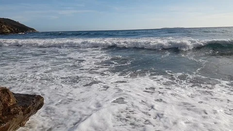 Slow motion view of a lonely bay in a sunny summer morning with rough sea Stock Footage 120247556