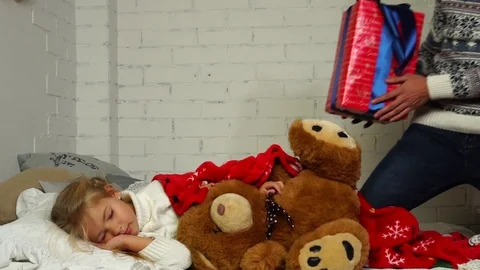 Slow motion view on loving dad carefully placing amazing wrapped Christmas gift Stock-Footage 98688158