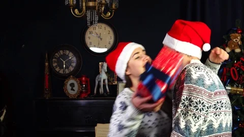 Slow motion view on loving dad carefully placing amazing wrapped Christmas gift Stock Footage 98695083