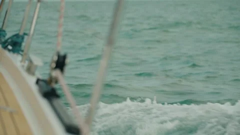 Slow-motion view over a sailboat bow as powerful North Sea waves splash across Stock Footage 343368812