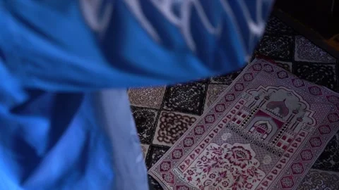 Slow motion view of praying man in blue wearing Stock Footage 256400251