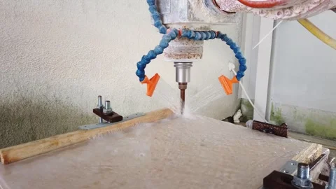 Slow motion view of robot working on milling sculpture in natural stone Stock Footage 329216022