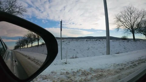 Slow Motion View of Snowy Fields and Mountains from Moving Car Stock Footage 326962024
