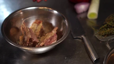 Slow motion view on soy sauce put on spicy delicious beef meat in steel mixing Stock Footage 105896543