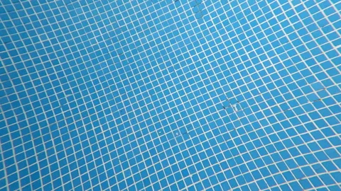 Slow Motion View of Swimming Pool Tile Pattern Beneath Moving Water 動画素材 342325187