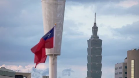 Slow motion view of Taiwan flag against Taipei 101 tower Stock Footage 317027153