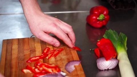 Slow motion view on thin slices of fresh cut vegetables onion red hot chili Stock Footage 105455031