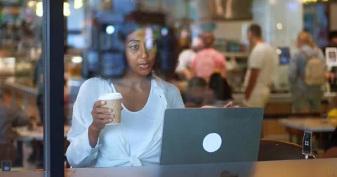 Slow motion: View through glass windows to a mixed race woman in casual clothes Stock Footage 227828242