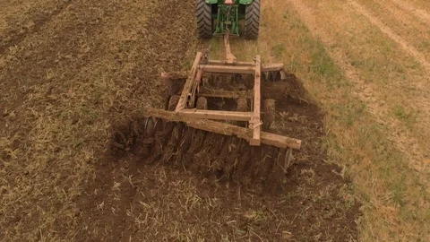 Slow motion view of tractor plowing a field a from drone Stock-Footage 95336208