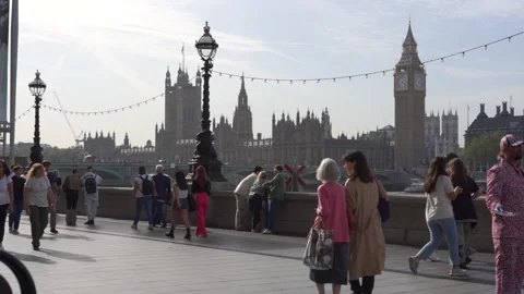 Slow motion view of traffic and pedestrians passing on Westminster Bridge Stock Footage 260022003