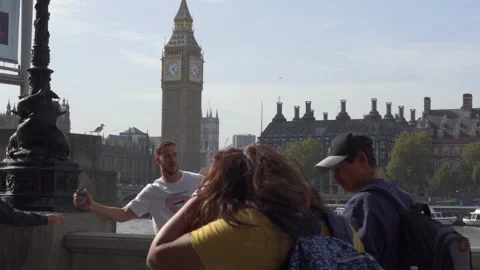 Slow motion view of traffic and pedestrians passing on Westminster Bridge Stock Footage 260022007